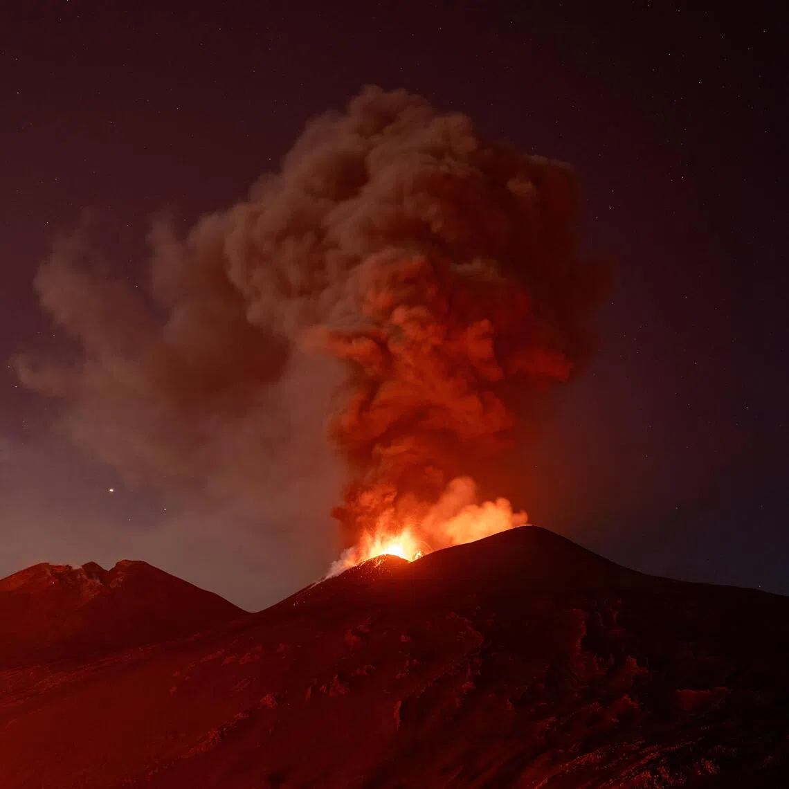 Volcanic material and fumes rising from Mount Etna during an eruption in Sicily on July 30.