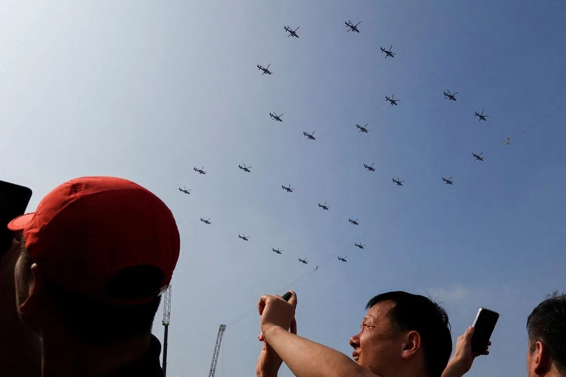 Military helicopters flying in the formation of the number 80 over Tiananmen Square during a military parade marking the 80th anniversary of victory over Japan and the end of World War II, in Beijing’s Tiananmen Square, China, on Sept 3, 2025. 