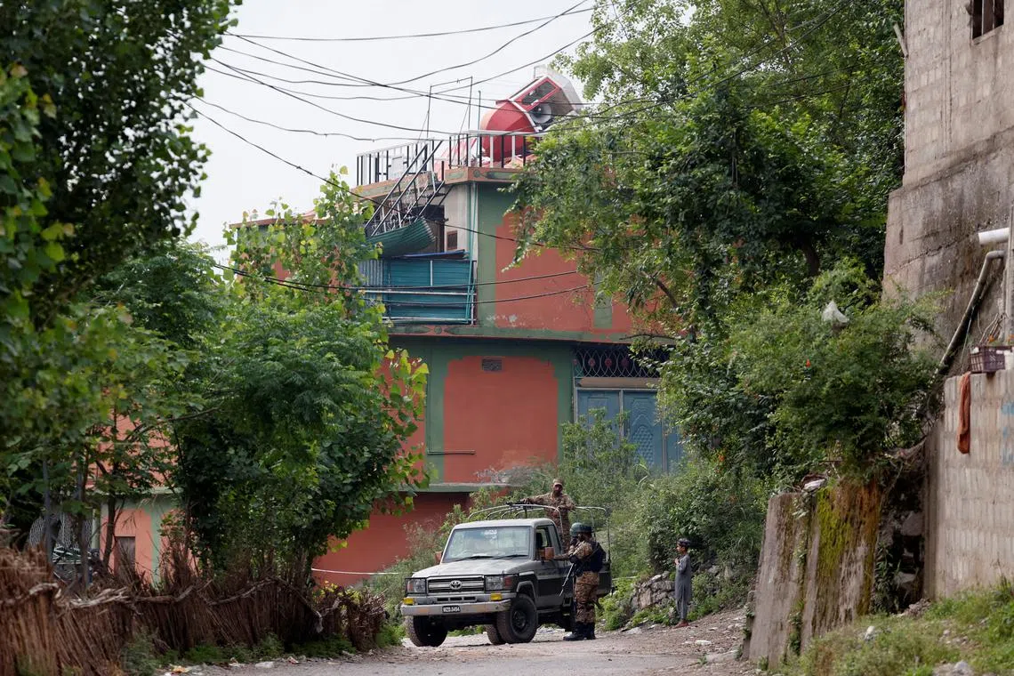 Security force personnel stand guard in front of Bilal Mosque after it was hit by an Indian strike in Muzaffarabad, the capital of Pakistan-administered Kashmir, May 7, 2025. REUTERS/Akhtar Soomro