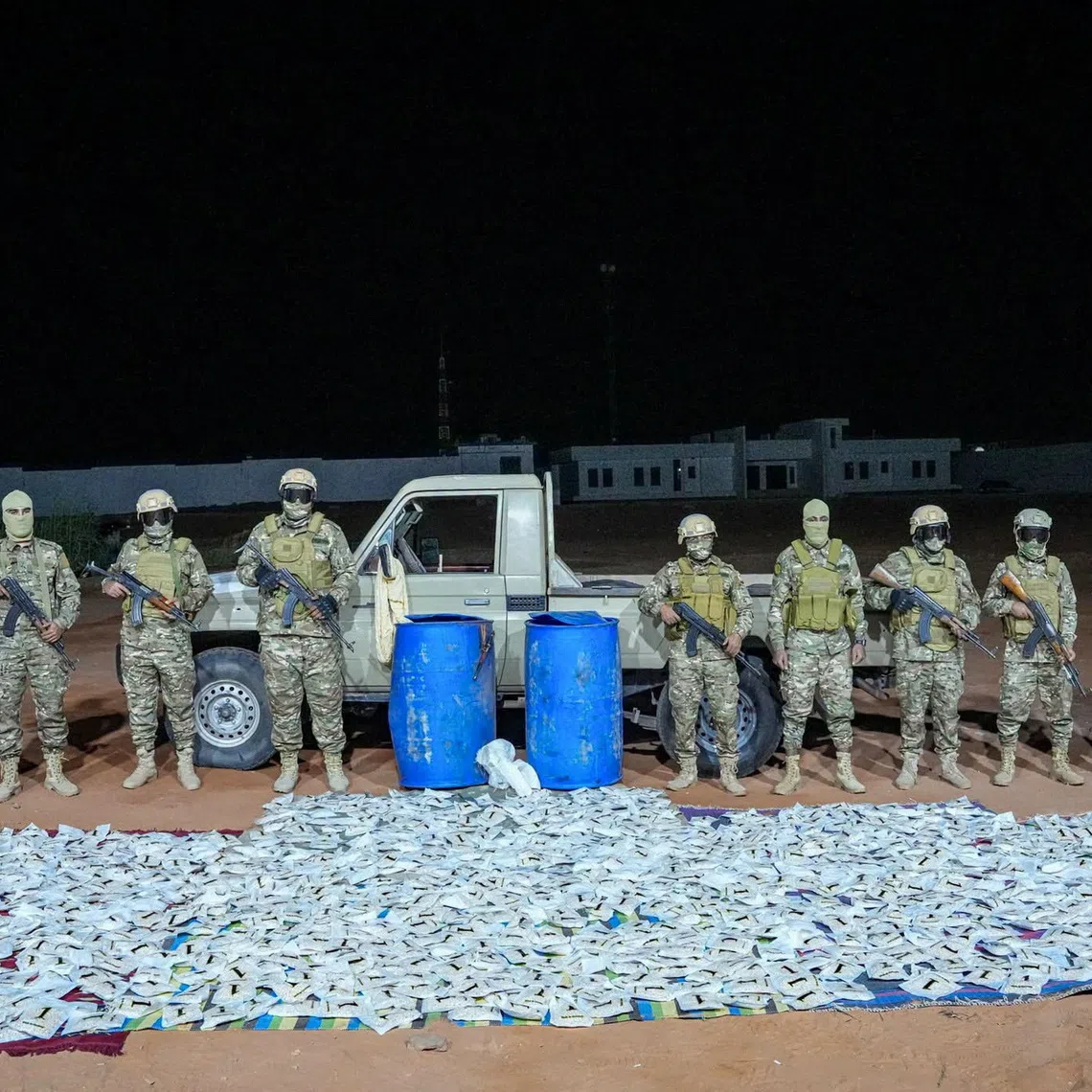 Members of the security forces stand next to a vehicle and seized narcotic pills after a security operation conducted by the Subul Al-Salam Infantry Brigade in a location given as Kufra, Libya, according to the military, in this photo released October 9, 2026. Libyan National Army/Handout via REUTERS