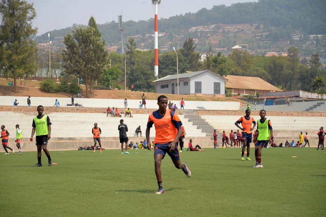 Umuri Foundation footballer Sharif Cyubahiro (centre), 16, in action during a training session at a football pitch adjacent to the Kigali Pele Stadium in the Nyamirambo district.