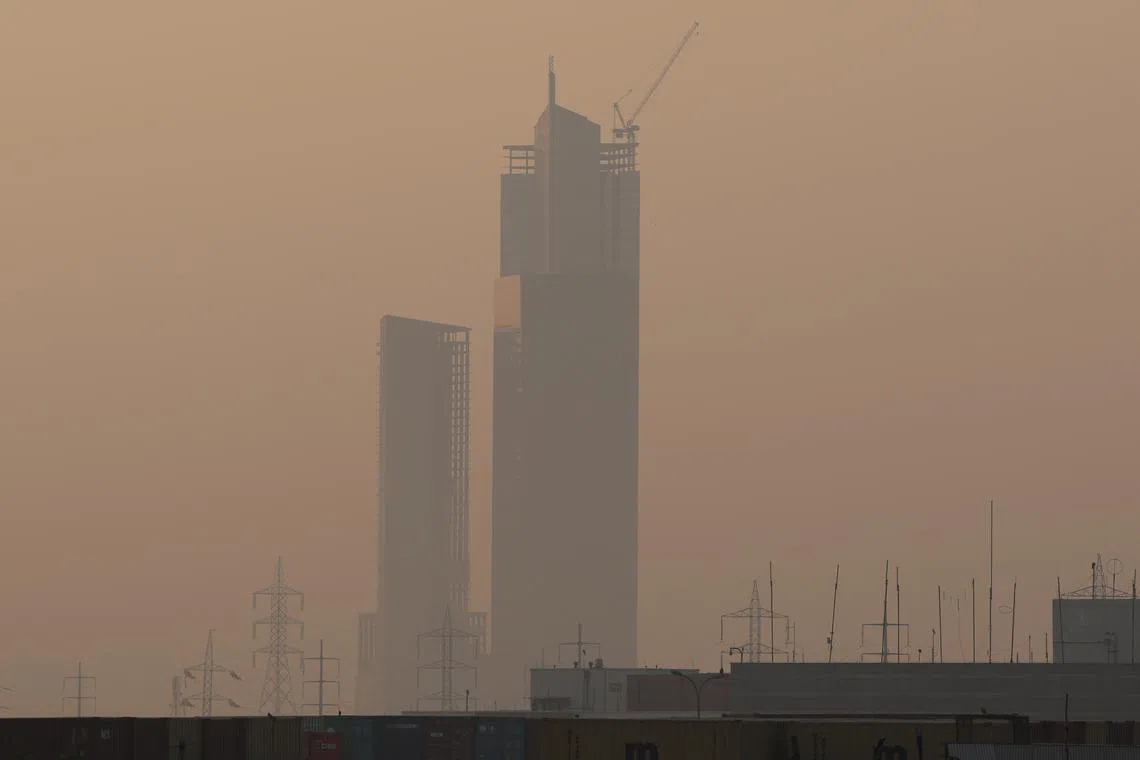 The 62-storey tower at the Bahria Icon Tower complex is seen through smog and air pollution on a morning in Karachi, Pakistan, November 15, 2024. REUTERS/Akhtar Soomro
