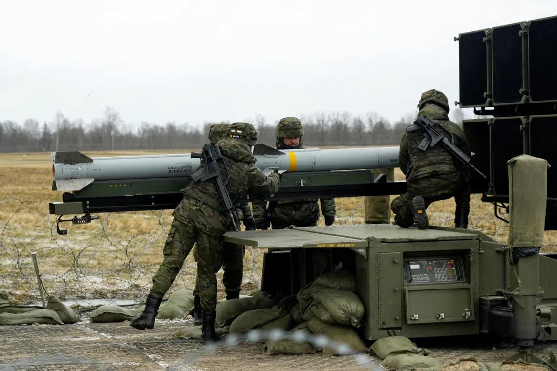 Spanish army servicemen prepare a NASAMS medium range ground-based air defence rocket launcher in Latvia.