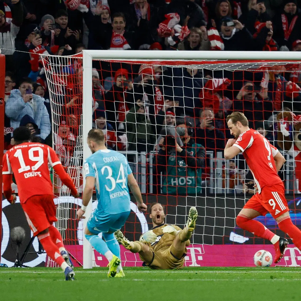 Soccer Football - Bundesliga - Bayern Munich v TSG 1899 Hoffenheim - Allianz Arena, Munich, Germany - February 8, 2026 Bayern Munich's Harry Kane celebrates scoring their first goal as TSG 1899 Hoffenheim's Oliver Baumann reacts REUTERS/Heiko B