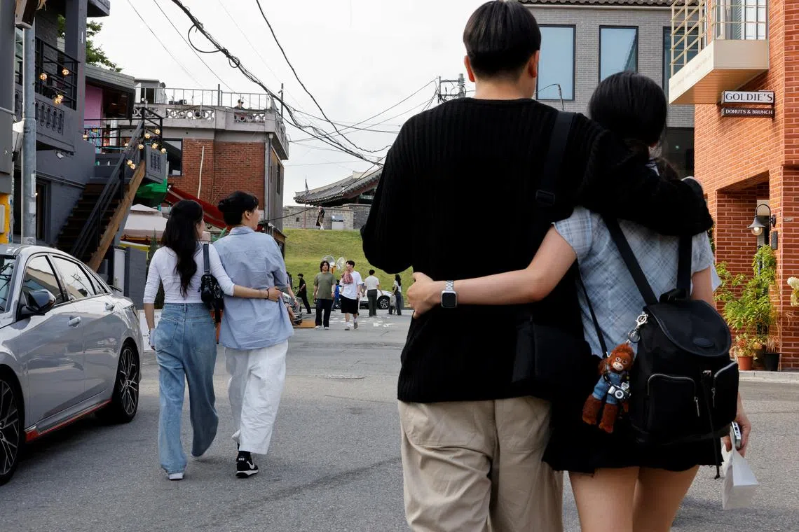 Kim Eun-ha, 33, and her lesbian partner Park Cho-hyeon, 28, walk on a street in Suwon, South Korea, June 15, 2024. REUTERS/Kim Soo-hyeon