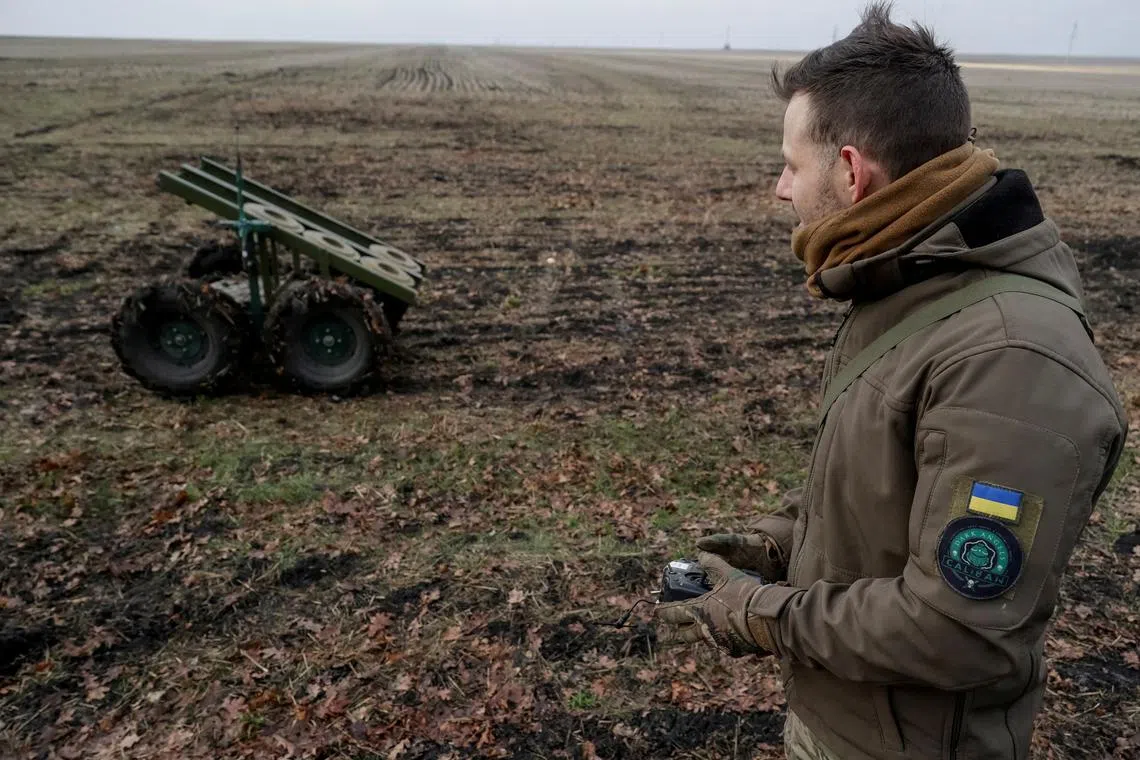 FILE PHOTO: A serviceman of 13th Operative Purpose Brigade 'Khartiia' of the National Guard of Ukraine operates a mine-laying unmanned ground vehicle with anti-tank landmines installed on it, in Kharkiv region, amid Russia's attack on Ukraine, January 13, 2025. REUTERS/Sofiia Gatilova/File Photo