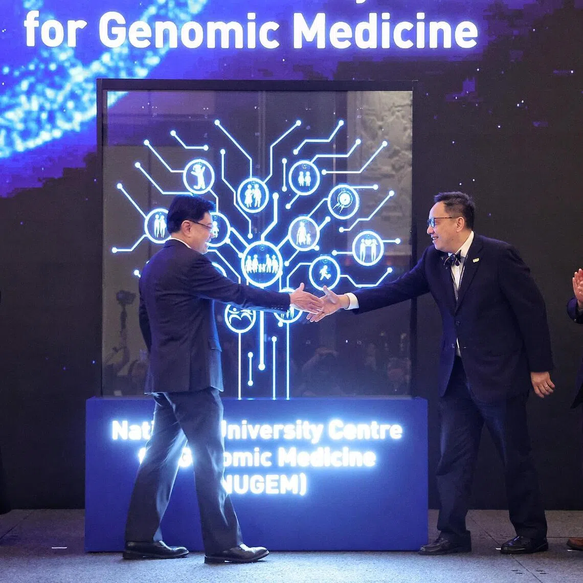 National Research Foundation chairman Mr Heng Swee Keat (centre left) and Professor Chong Yap Seng, deputy chief executive (Education and Research) of National University Health System (NUHS) and Dean of the National University of Singapore Yong Loo Lin School of Medicine, shaking hands to mark the launch of the National University Centre for Genomic Medicine by NUHS during its biennial Scientific and Innovation Summit at Shangri-La Hotel on April 2, 2026. ST PHOTO: KEVIN LIM azgenome02
