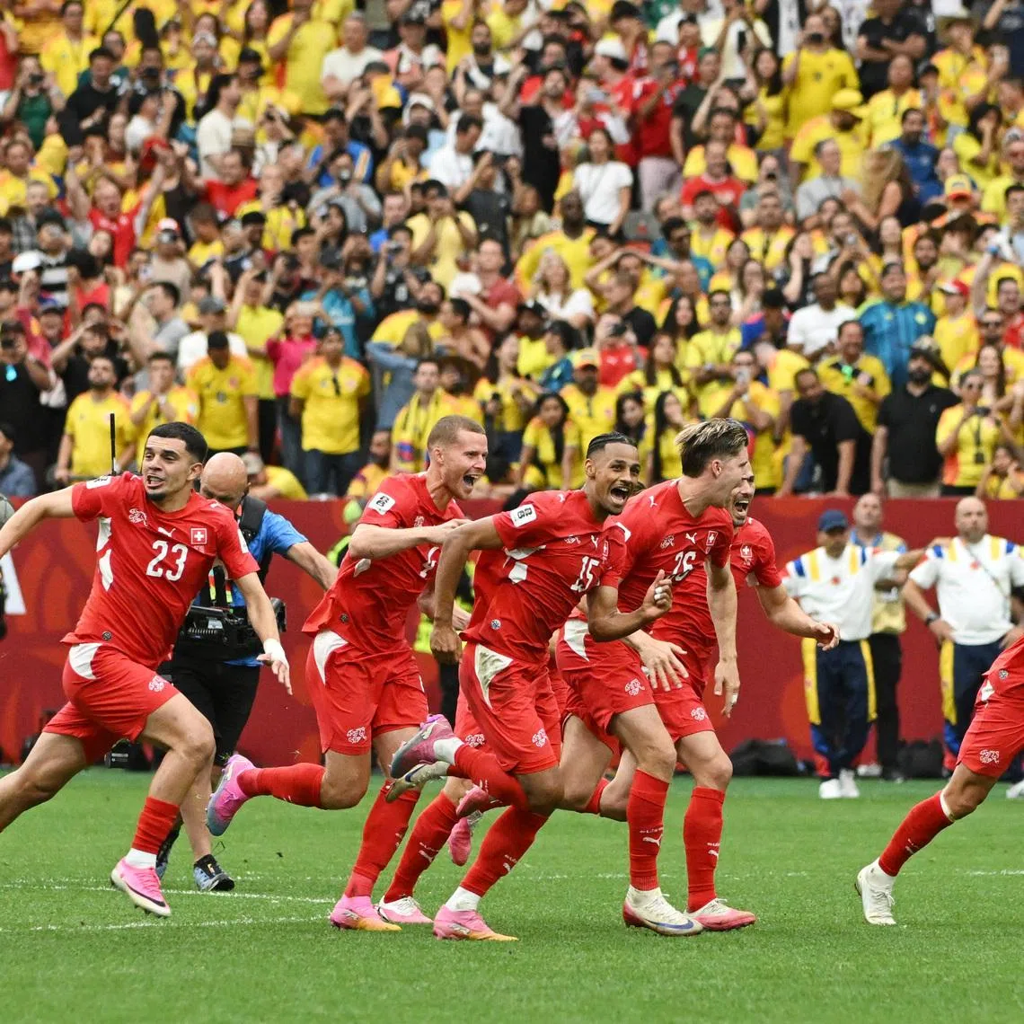 Switzerland players celebrate after winning the penalty shoot-out against Colombia on July 7.