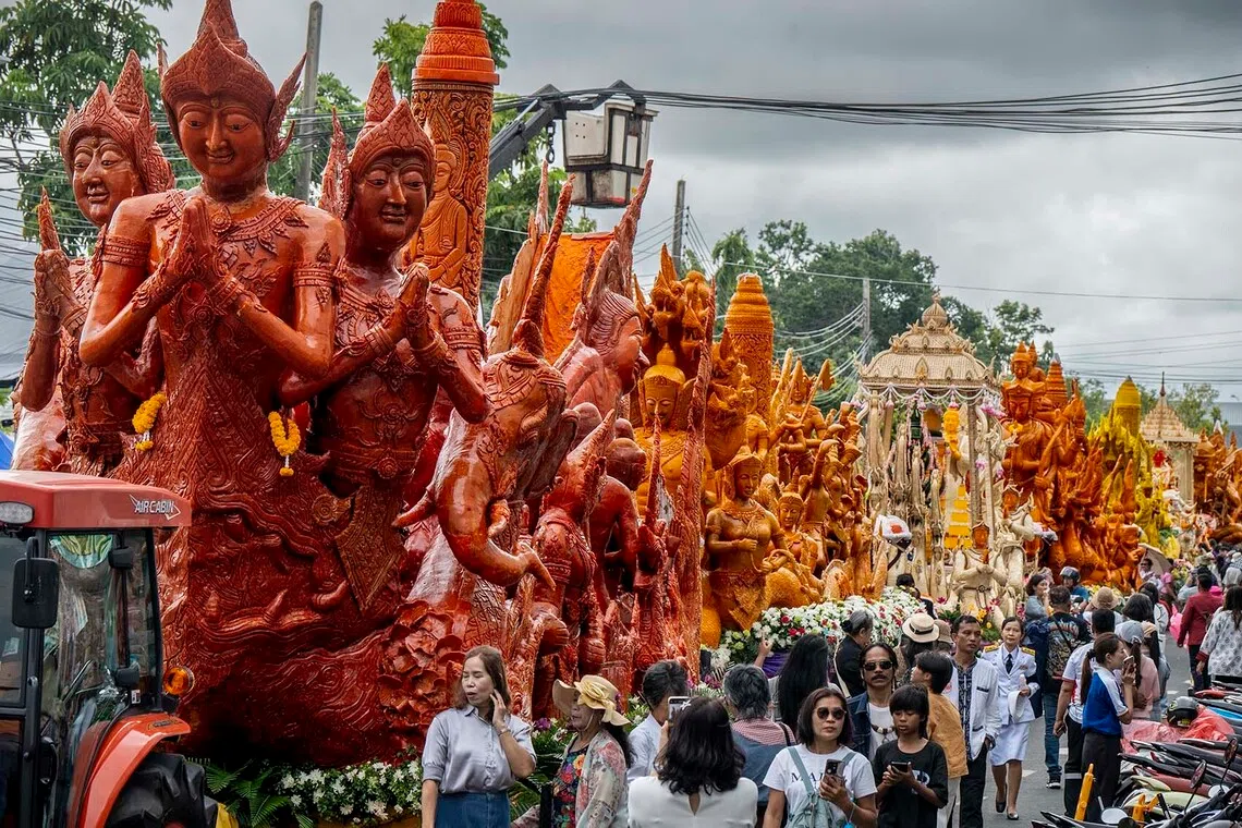epa13141841 A row of traditional floats stands in a line before taking part in a parade procession on the second day of the Ubon Ratchathani Candle Festival in Ubon Ratchathani, Thailand, 29 July 2026 (issued 30 July 2026). The festival marks the beginning of Buddhist Lent (Khao Phansa) featuring grand candle-wax sculpture parades alongside traditional music and dance performances from 28 to 30 July. EPA/ADRYEL TALAMANTES ATTENTION: This Image is part of a PHOTO SET