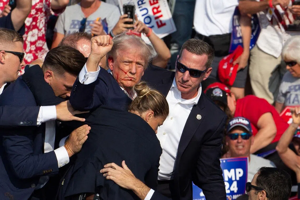 Secret service agents escort Republican presidential candidate Donald Trump offstage, after he was shot at a rally in Pennsylvania.