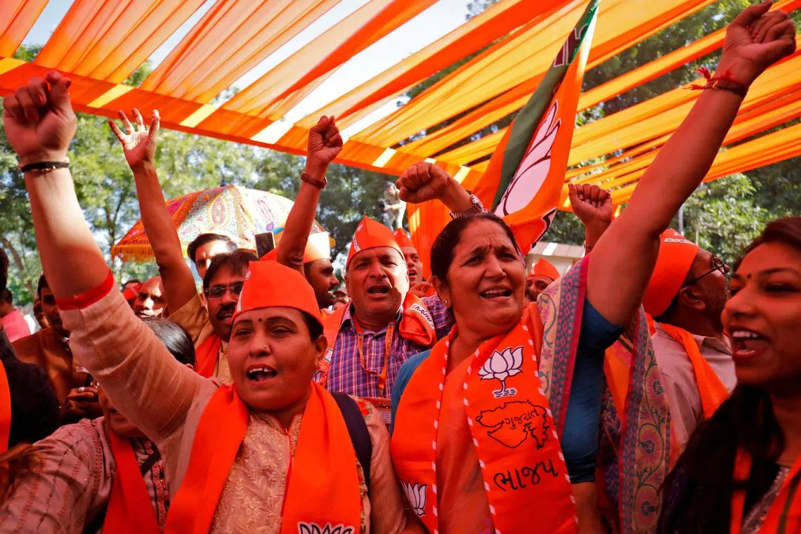Supporters of India's ruling Bharatiya Janata Party celebrate in Gandhinagar, India, on Dec 8, 2022.