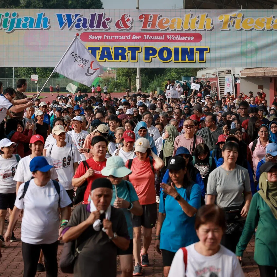 Advisers to Marsiling-Yew Tee GRC GROs, Senior Minister of State Zaqy Mohamad, Mayor Alex Yam and Ms Hany Soh flagging-off a walk during the Hijrah Walk & Health Fiesta held at Choa Chu Kang Stadium on June 28, 2025.