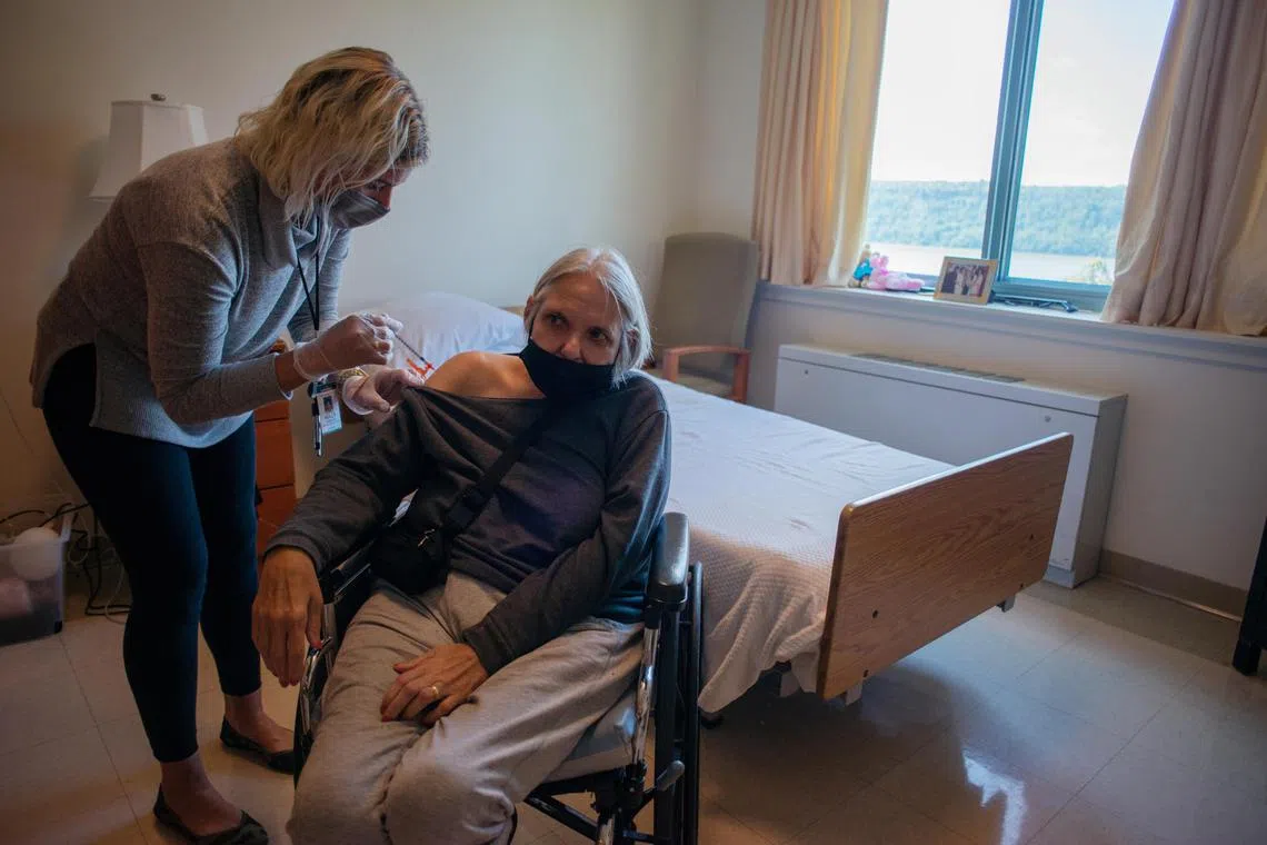 A resident gets the new bivalent Omicron booster shot at the Hebrew Home at Riverdale, a nursing care facility in the Bronx, New York.