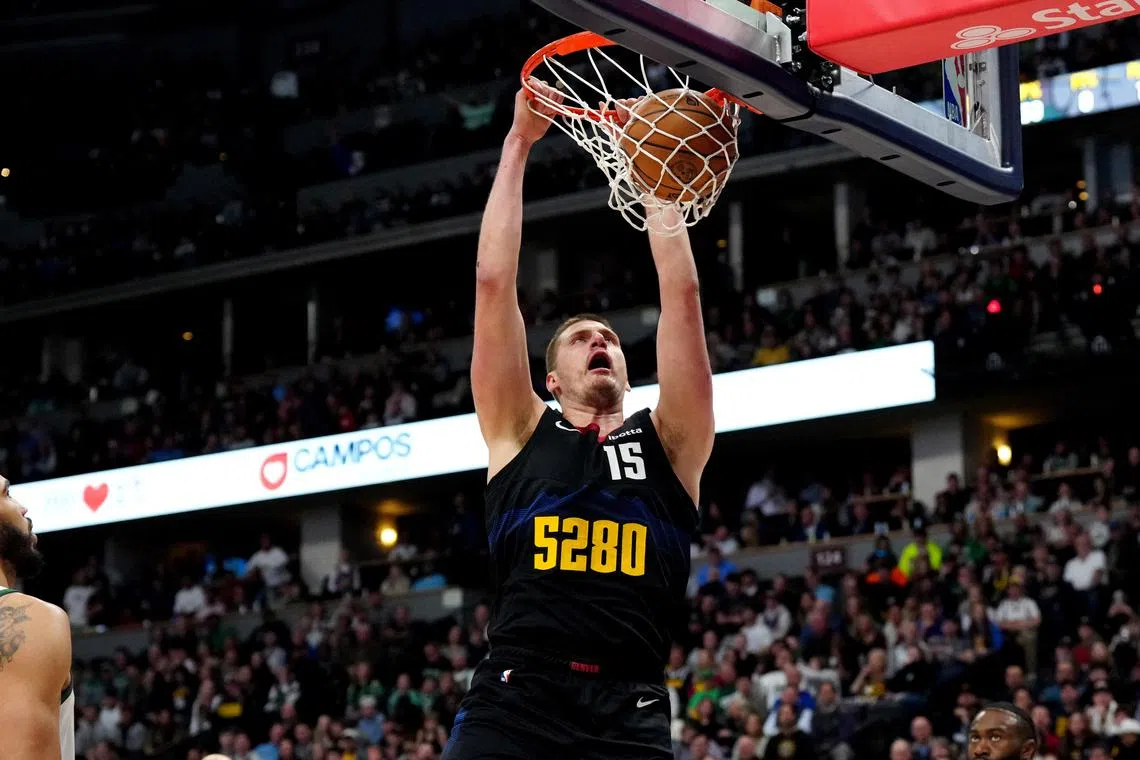 Denver Nuggets centre Nikola Jokic dunking in the first quarter against the Boston Celtics at Ball Arena.