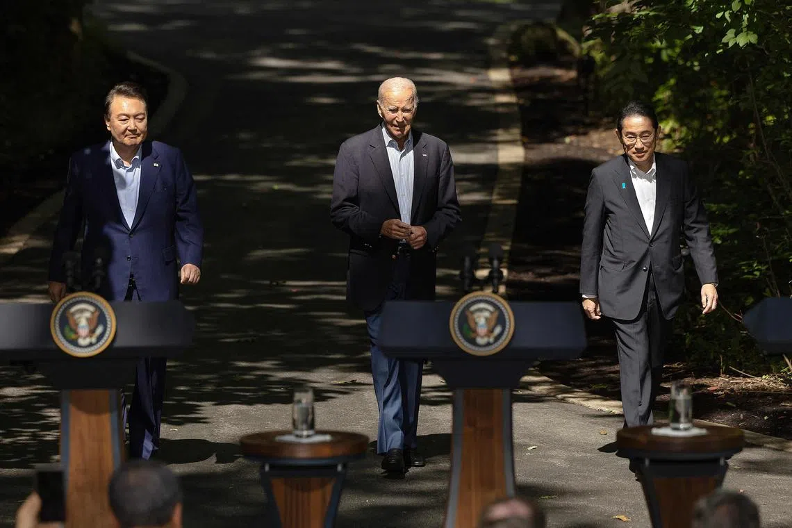 CAMP DAVID, MARYLAND - AUGUST 18: (L-R) Korean President Yoon Suk Yeol, U.S. President Joe Biden and Japanese Prime Minister Kishida Fumio arrive for a joint news conference following three-way talks at Camp David on August 18, 2023 in Camp David, Maryland. Biden hosted the trilateral summit at the presidential retreat near Thurmont, Maryland, where the leaders discussed moving forward in "lockstep" on issues related to military cooperations, international politics, countering China and North Korea and other topics.   Chip Somodevilla/Getty Images/AFP (Photo by CHIP SOMODEVILLA / GETTY IMAGES NORTH AMERICA / Getty Images via AFP)