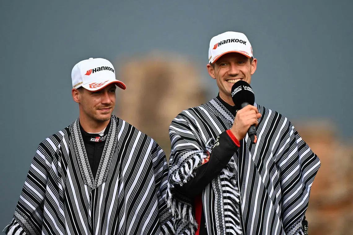 Frenchman Sebastien Ogier speaks next to Toyota co-driver Vincent Landais after winning the WRC Rally Paraguay, 10th stage of the FIA World Rally Championship, at the Ruins of Trinidad, Itapua department, Paraguay on Aug 31, 2025.