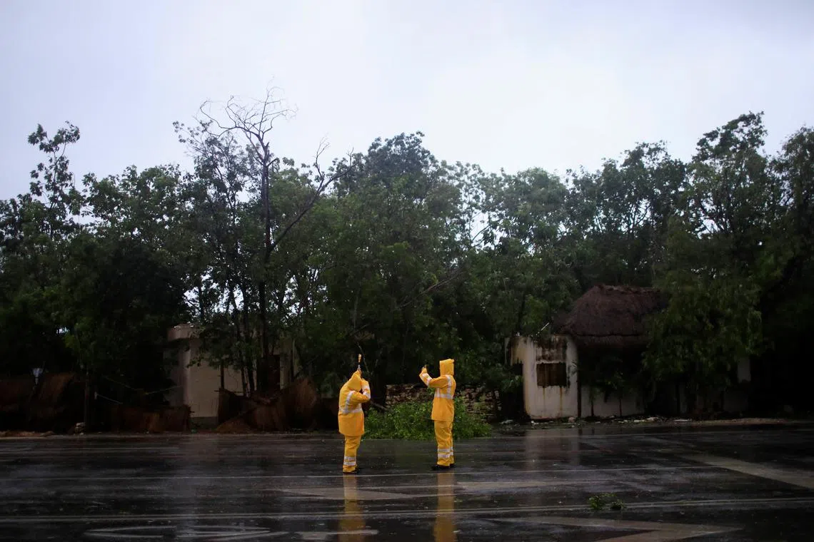 Geographers take measurements as Hurricane Beryl, a Category 2 storm, made landfall in Mexico's top tourist destinations early on Friday, in Tulum, Mexico, July 5, 2024. REUTERS/Raquel Cunha