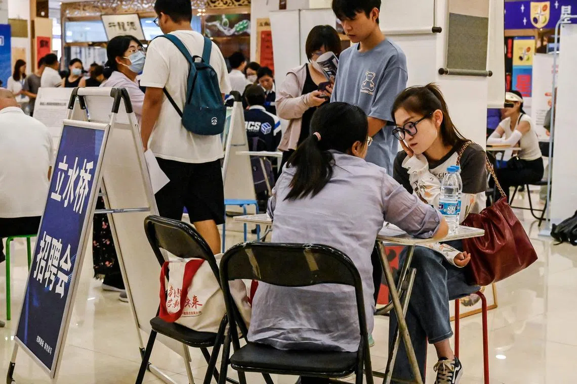 People attending a job fair in Beijing on Aug 19.