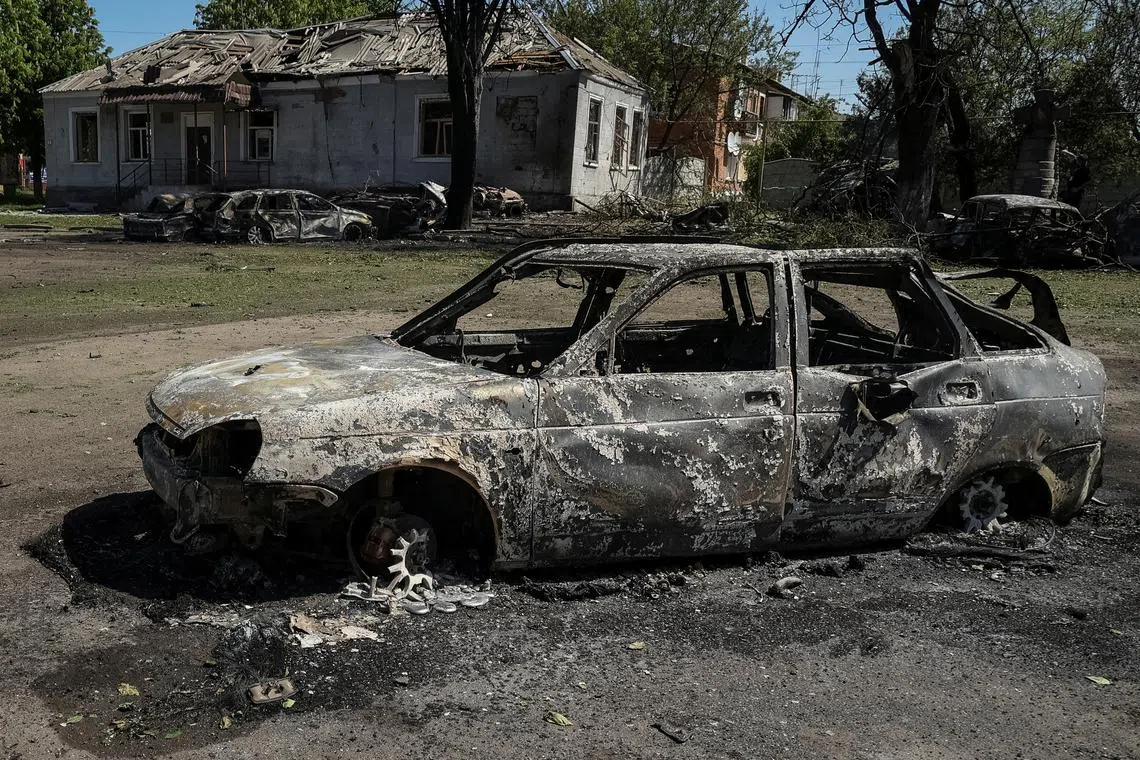 Destroyed cars are seen at a site of a Russian missile strike, amid Russia's attack on Ukraine, in the village of Zolochiv in Kharkiv region, Ukraine May 1, 2024. REUTERS/Sofiia Gatilova