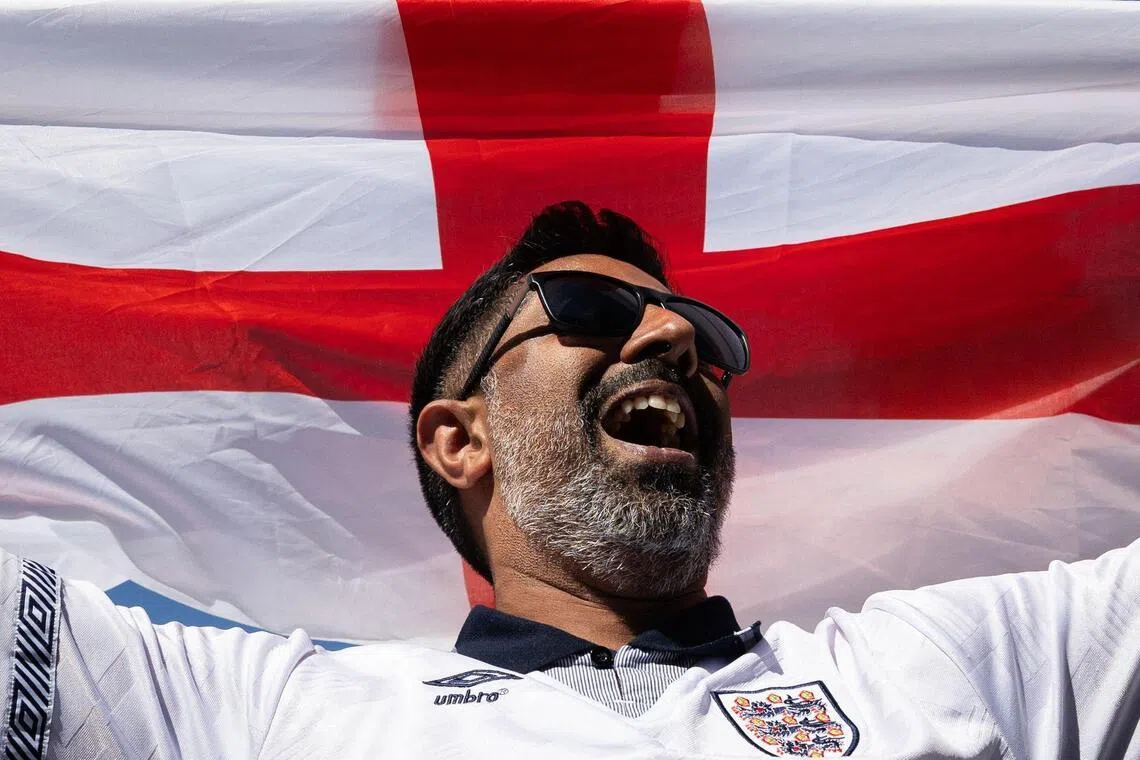 An England's fan cheers during a viewing party for the World Cup third-place football match between France and England in Burbank, California, on July 18, 2026. (Photo by Blake Fagan / AFP)
