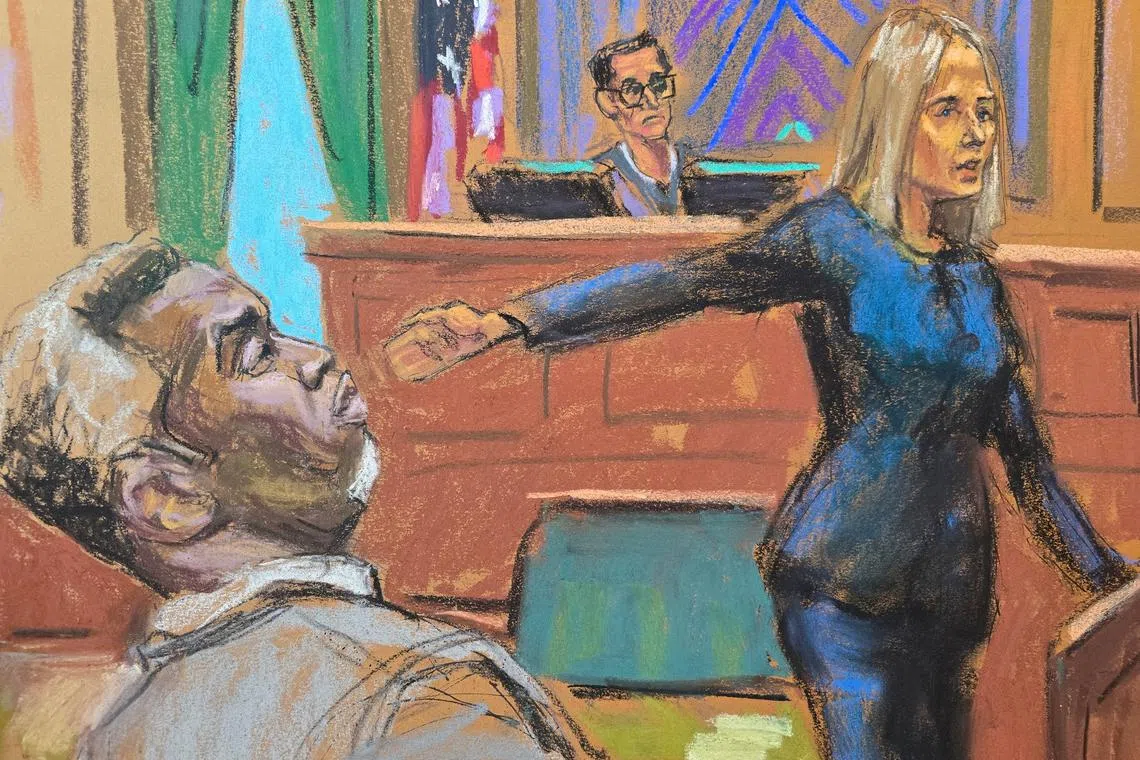 Prosecutor Emily Johnson points to Sean \"Diddy\" Combs before U.S. District Judge Arun Subramanian at Combs' sex trafficking trial in New York City, New York, U.S., May 12, 2025, in this courtroom sketch. REUTERS/Jane Rosenberg