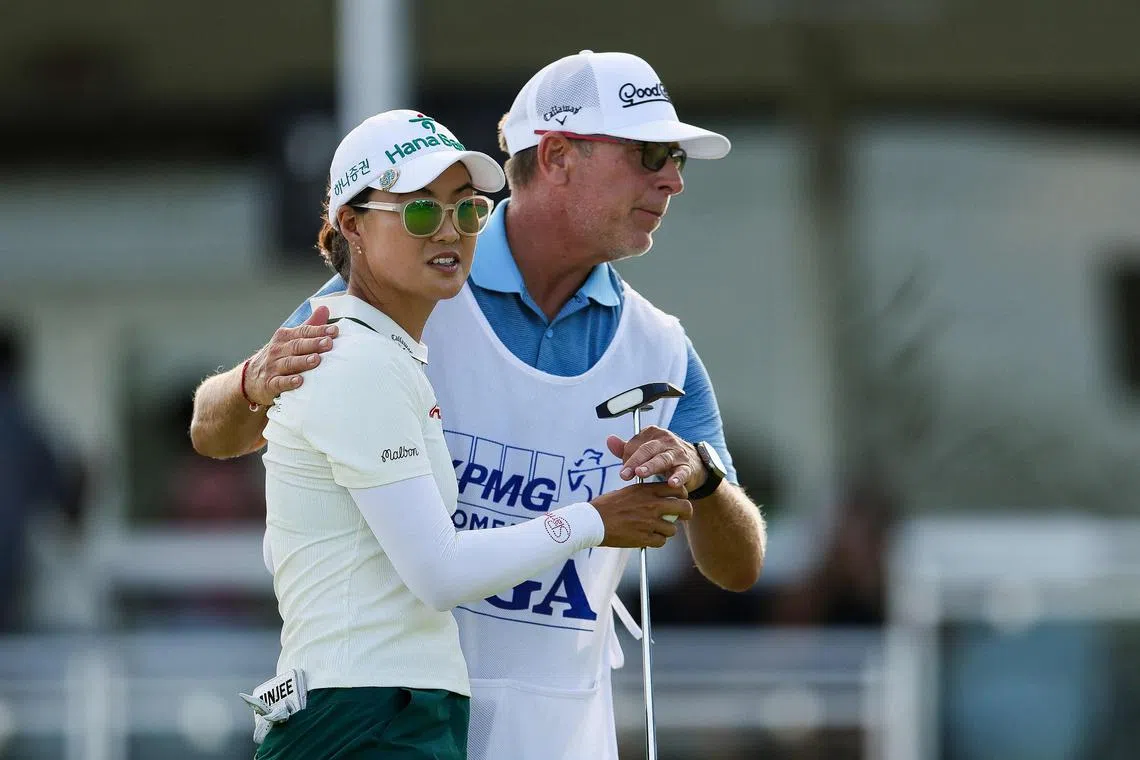 Leader Minjee Lee of Australia hugging her caddie on the 18th hole green after finishing the third round of the KPMG Women's PGA Championship 2025 at Fields Ranch East at PGA Frisco on June 21, 2025 in Frisco, Texas.