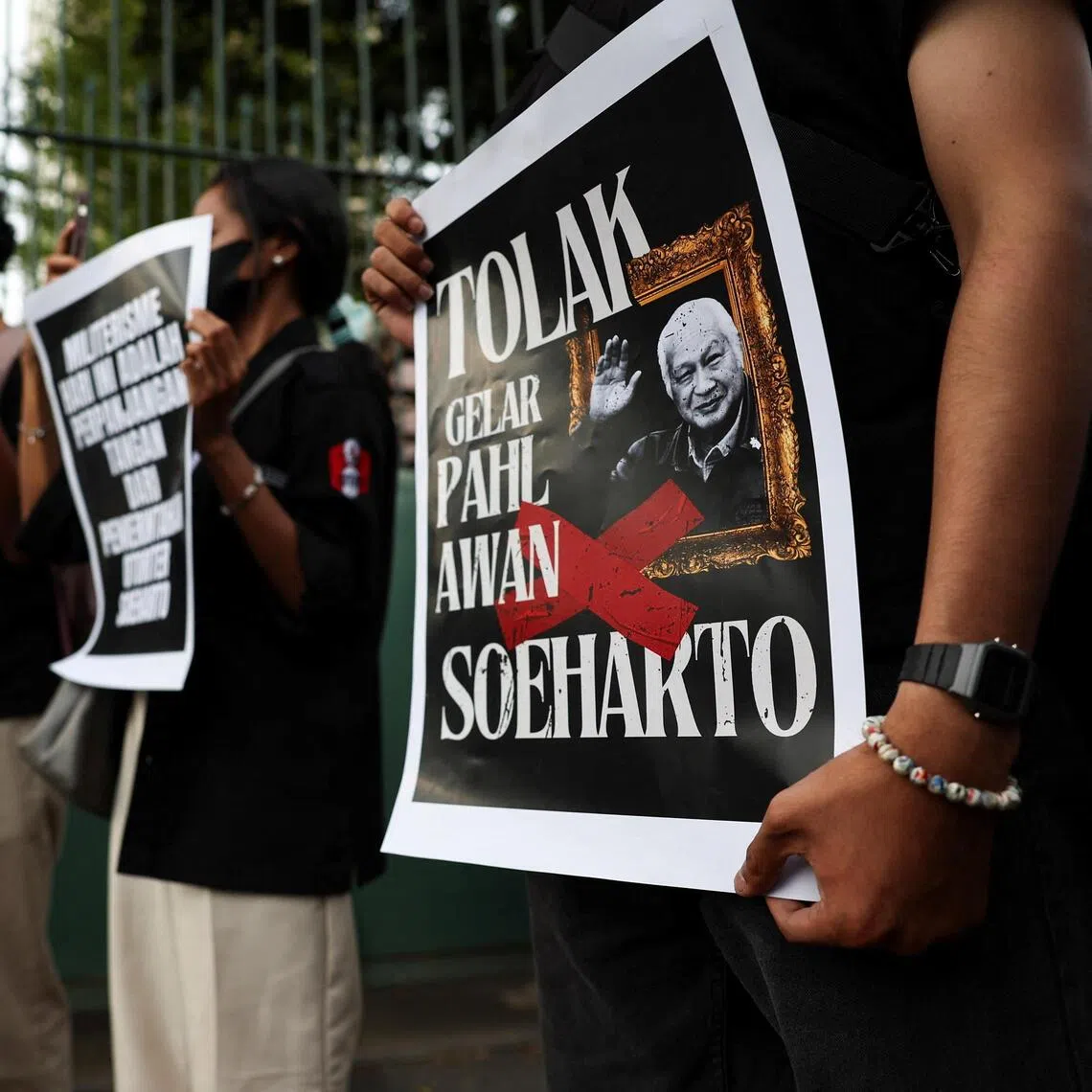 Activists during a protest against former Indonesian President Suharto, who was named a national hero, outside the Ministry of Culture building in Jakarta, Indonesia, on Nov 10.