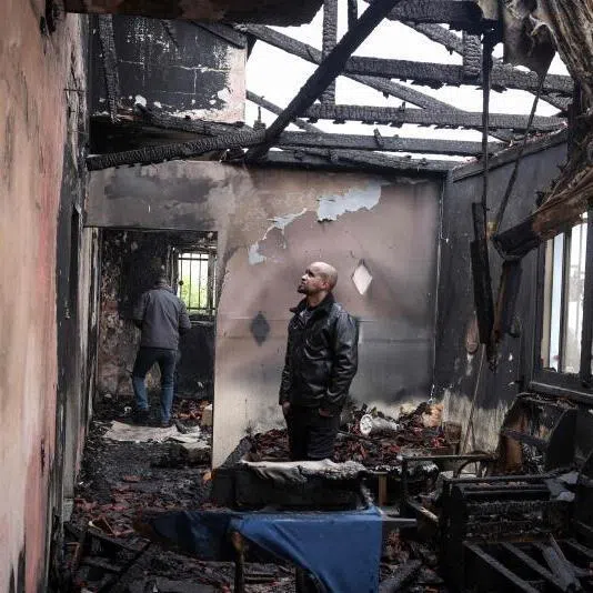 A Palestinian man inspects the remains of his burnt-out family home following a reported attack by Israeli settlers in the village of Fandaqumiya, south-west of Jenin, in the Israeli-occupied West Bank.
