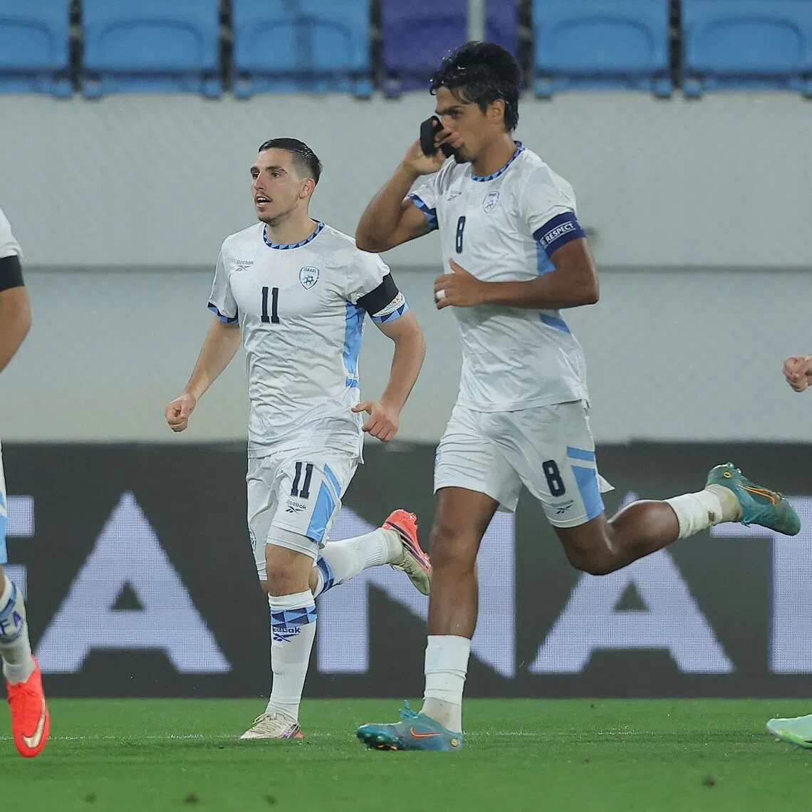 Israel’s midfielder Dor Peretz (second from right) kisses his black armband as he celebrates scoring Israel’s first goal during the UEFA Nations League Group B3 match against Ireland in Backa Topola on Oct 4.