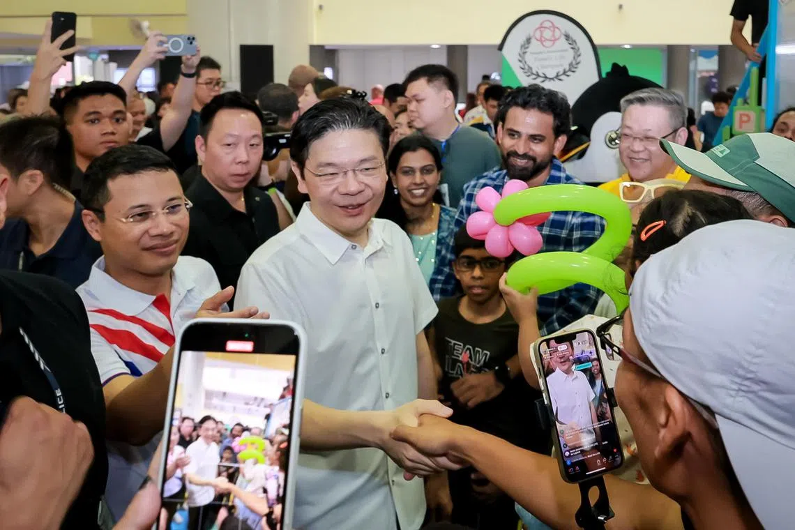 Prime Minister Lawrence Wong with West Coast GRC MP Desmond Lee greeting residents at the PA Family PLAYGround event at West Coast Community Centre on July 13.