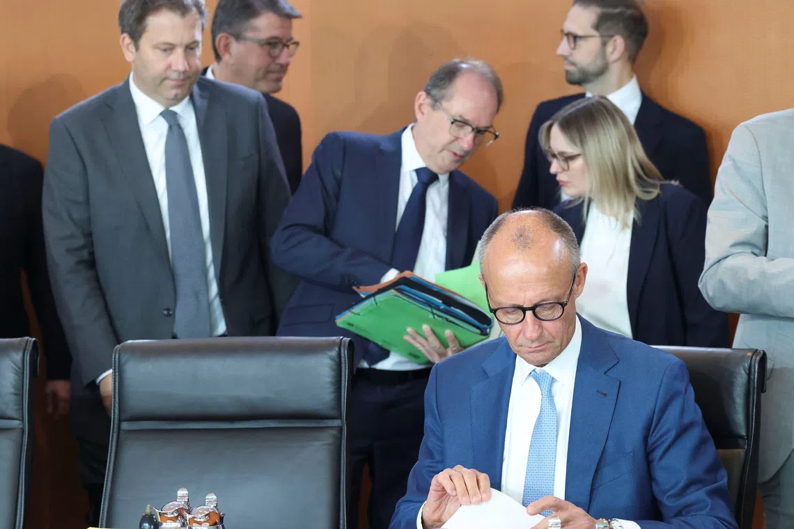 German Chancellor Friedrich Merz waits for a cabinet meeting next to Interior Minister Alexander Dobrindt and Finance Minister Lars Klingbeil at the Chancellery in Berlin, Germany, October 7, 2026. REUTERS/Leonhard Foeger