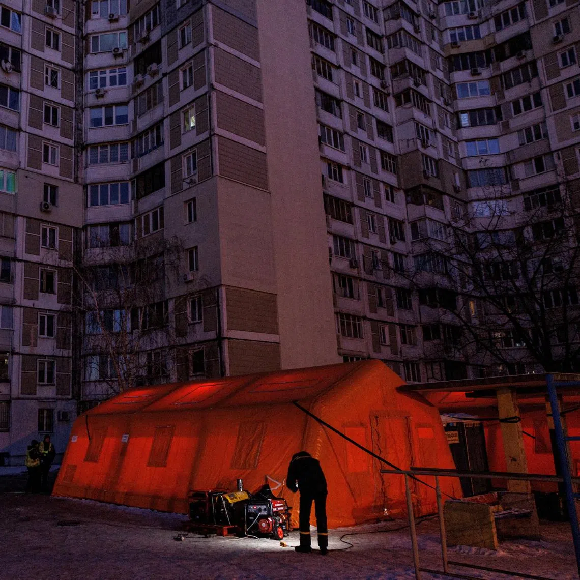 A State Emergency Service employee checks a generator next to a tent of a government-run humanitarian aid point in Kyiv on Jan 20.