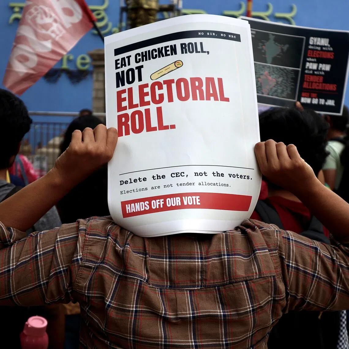 Members of the All India Students’ Association, social activists and members of the Cockroach Janta Party hold placards and shout slogans during a protest against the central government over voter-list revisions.