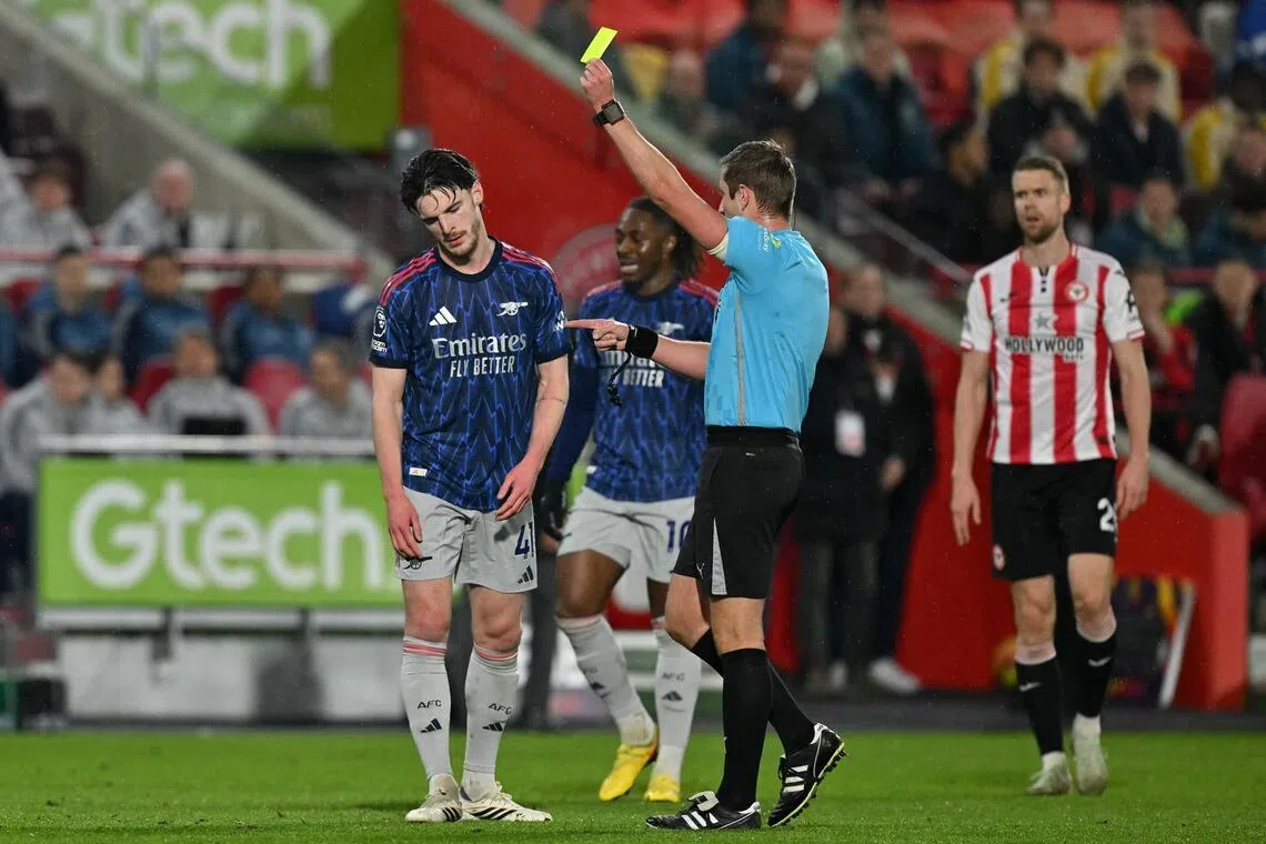 Referee John Brooks showing a yellow card to Arsenal midfielder Declan Rice during the 1-1 English Premier League draw with Brentford at the Brentford Community Stadium in London on Feb 12, 2026.
