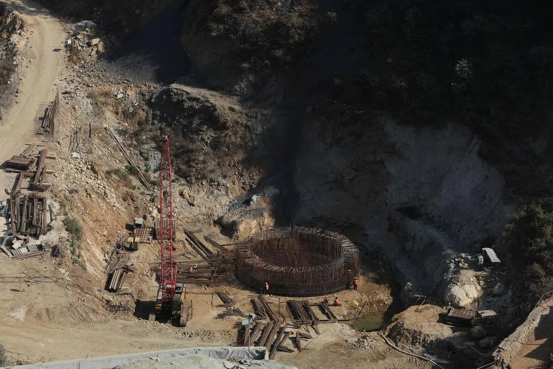 Construction of a railway line and infrastructure work is photographed from the village Maroda, in the northern state of Uttarakhand, India, Jan 17, 2023. 