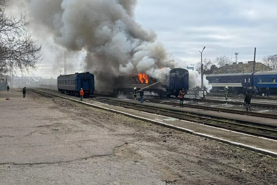 Firefighters extinguish a passenger train after it was hit by a Russian drone strike, amid Russia's attack on Ukraine, at a railway station in Mykolaiv region, Ukraine March 4, 2026.  Deputy Prime Minister for Restoration of Ukraine - Minister for Communities and Territories Development Oleksii Kuleba via Facebook/Handout via REUTERS