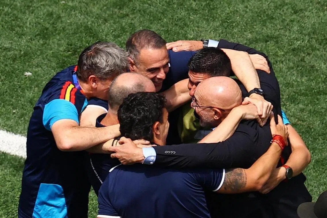 Spain coach Luis de La Fuente and staff celebrating after their World Cup win over Belgium.