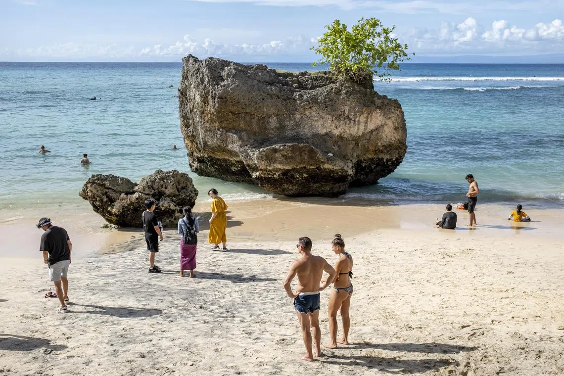 Tourists walking on a beach in Padang Padang, Bali, Indonesia. The Indonesian Tourism Ministry said the country will be ready to welcome tourists from China.