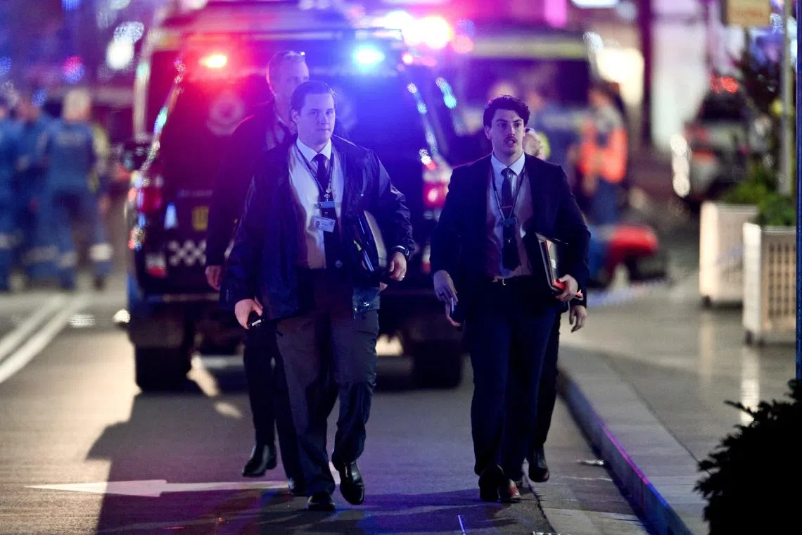Police officers and emergency service workers are seen at Bondi Junction after multiple people were stabbed inside the eastern suburbs shopping centre in Sydney, April 13, 2024. AAP Image/Steve Markham via REUTERS