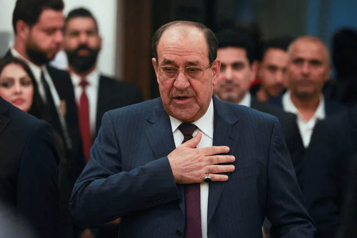 FILE PHOTO: Former Iraqi Prime Minister Nouri al-Maliki gestures as he arrives to vote during Iraq's provincial council elections, at a polling station in Baghdad, Iraq, December 18, 2023. REUTERS/Ahmed Saad/File Photo