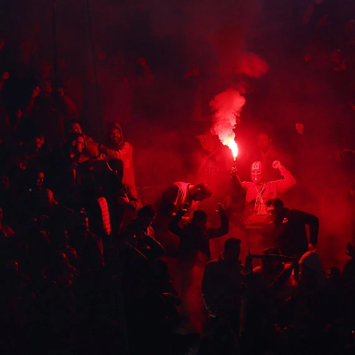Soccer Football - UEFA Champions League - Play Off - Second Leg - Juventus v Galatasaray - Allianz Stadium, Turin, Italy - February 25, 2026 Galatasaray fan with a flare after Victor Osimhen scores their first goal REUTERS/Guglielmo Mangiapane