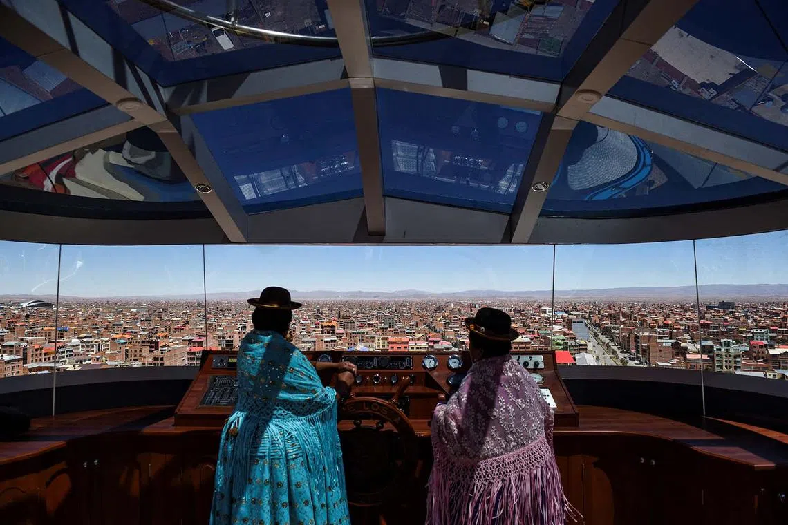 Two indigenous women observe the landscape at the top of the Cholet "El Crucero de los Andes" building which has the highest viewpoint in the world at 4,101 metres above sea level, in El Alto, Bolivia Sept 9.