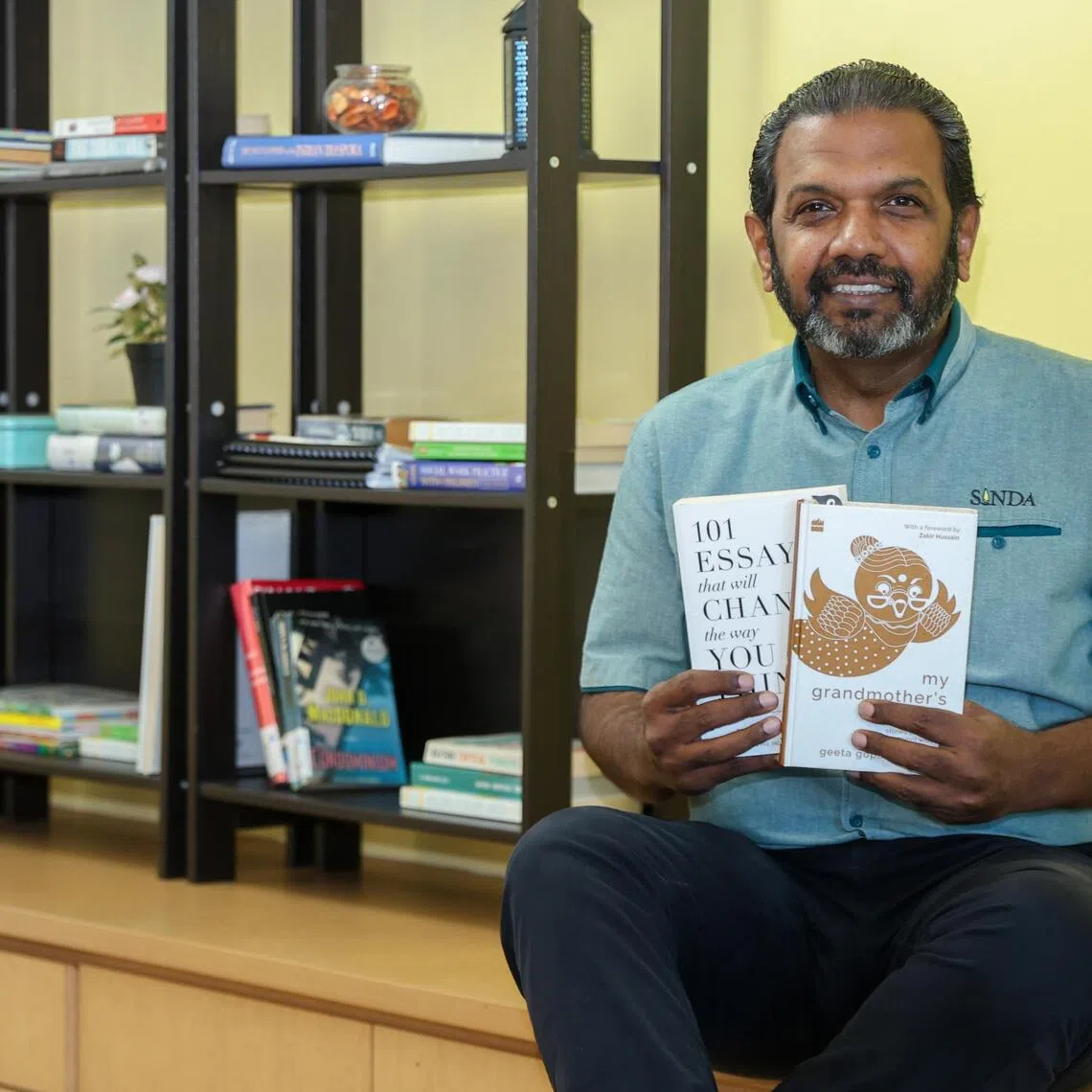 ST20260624_202670000268/Sarah Lee/shtalk
Singapore Indian Development Association (SINDA) chief executive officer Anbarasu Rajendran, 54, photographed at the SINDA Headquarters with his books.