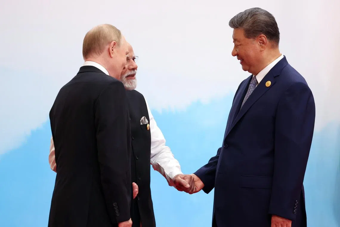 Chinese President Xi Jinping with Indian Prime Minister Narendra Modi and Russian President Vladimir Putin at the Shanghai Cooperation Organization (SCO) summit in Tianjin, on Sept 1.