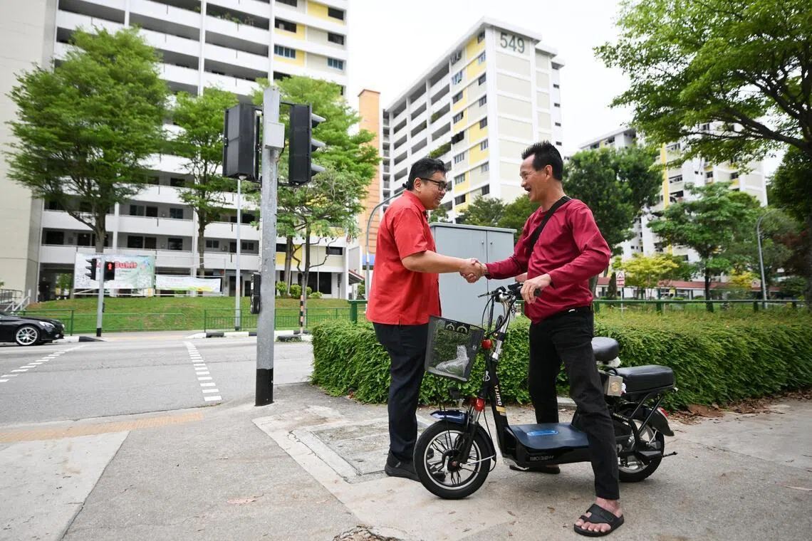WP Aljunied GRC MP Fadli Fawzi interacting with technician Eric Lau
on May 8. Mr Fadli wants to give more context in his Facebook posts so people
better understand how Parliament works.