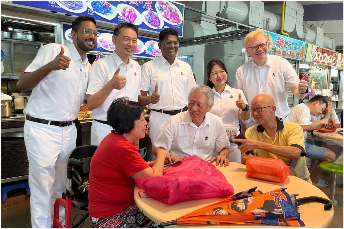 Senior Minister Teo Chee Hean and PAP's Aljunied GRC candidates interacting with residents at Bedok 538 Market and Food Centre on April 25.