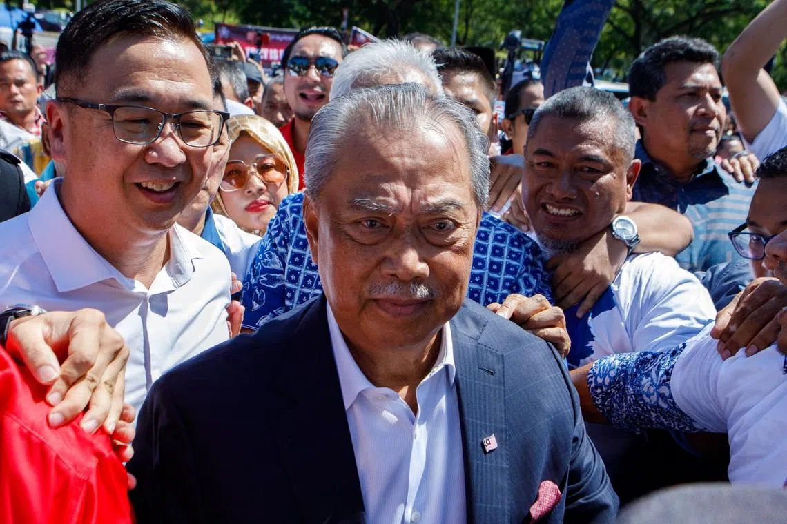 Former premier Muhyiddin Yassin (centre) arrives at the Malaysian Anti-Corruption Commission headquarters in Putrajaya, on March 9.