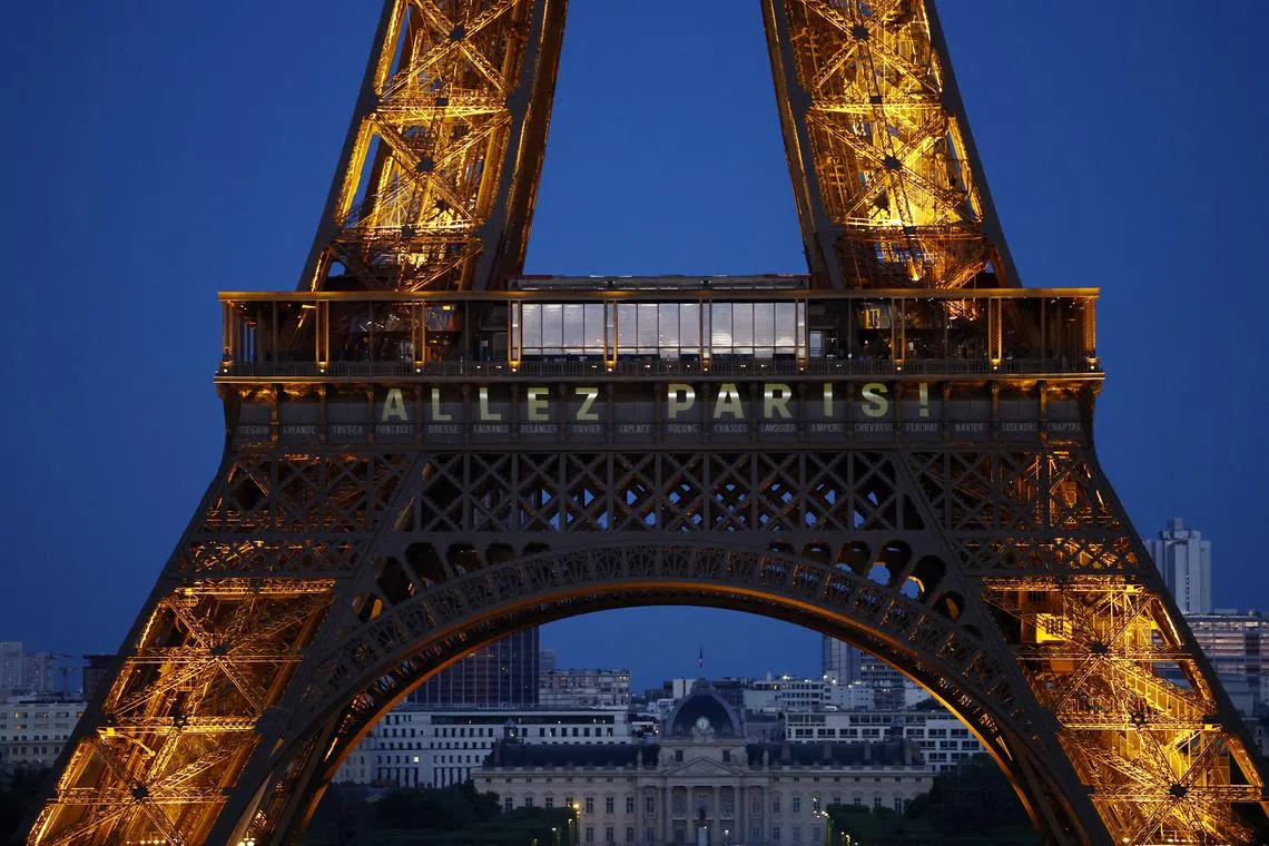 FILE PHOTO: Soccer Football - Champions League - Final - Paris St Germain v Inter Milan Preview - Paris, France - May 30, 2025 A message is displayed in the Eiffel Tower that reads: 'Allez Paris!' ahead of the final REUTERS/Abdul Saboor/File Photo