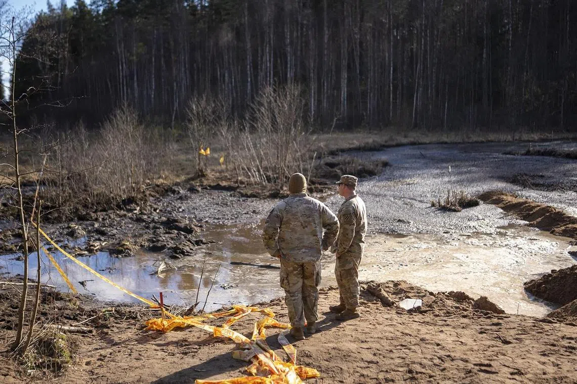 Military personnel at the site of a rescue operation for missing US soldiers in Lithuania, on March 27.