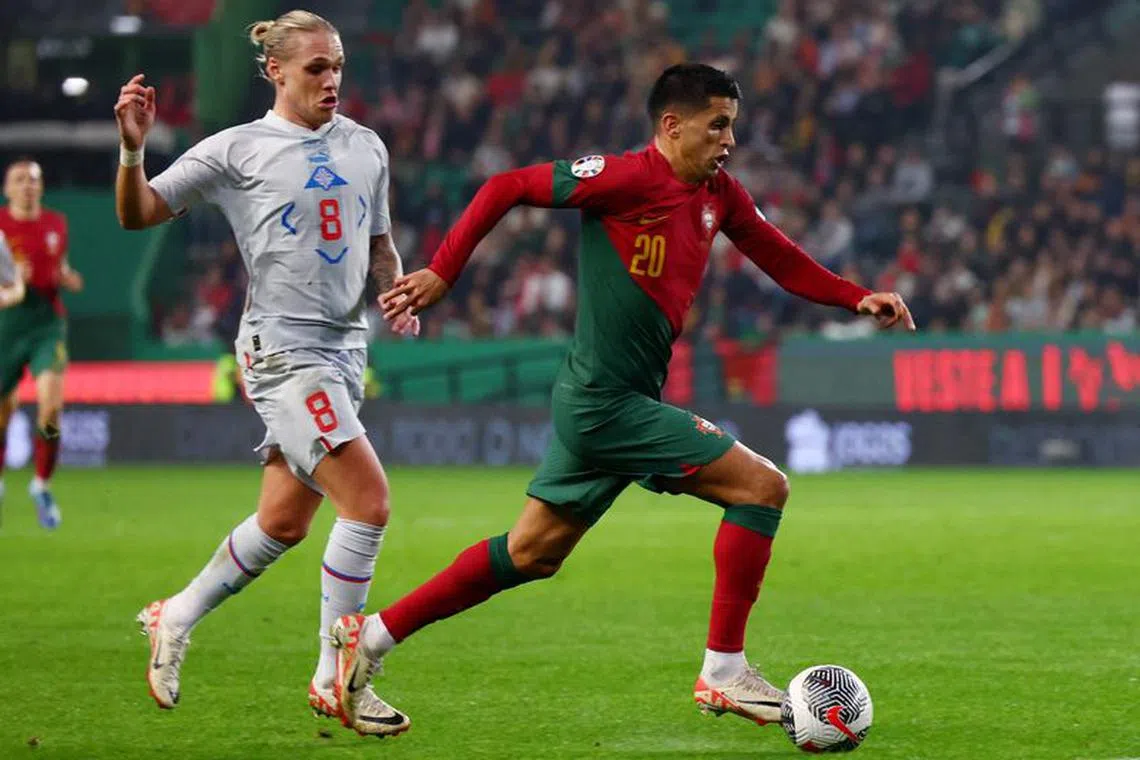 Soccer Football - Euro 2024 Qualifier - Group J - Portugal v Iceland - Estadio Jose Alvalade, Lisbon, Portugal - November 19, 2023  Portugal's Joao Cancelo in action with Iceland's Arnor Sigurdsson REUTERS/Pedro Nunes
